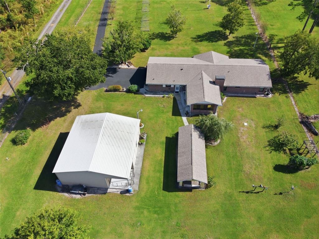 9240 Moore Road Lakeland, FL 33809 - Photo 42 of 61 an aerial view of a house with swimming pool and large trees