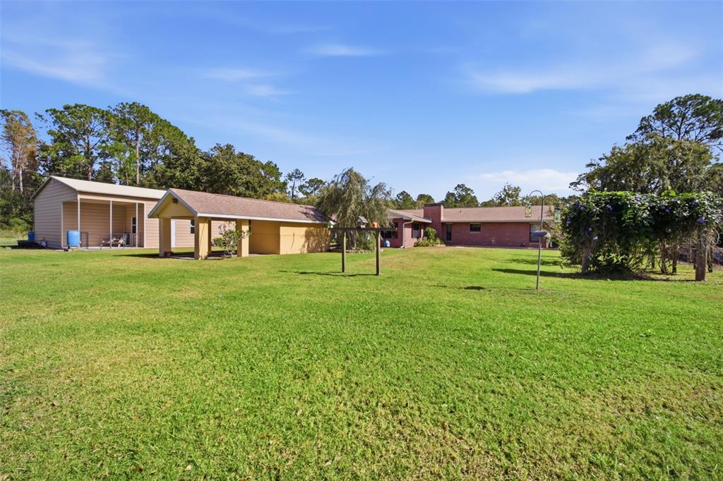 9240 Moore Road Lakeland, FL 33809 - Photo 57 of 61 a view of a house with a yard and sitting area