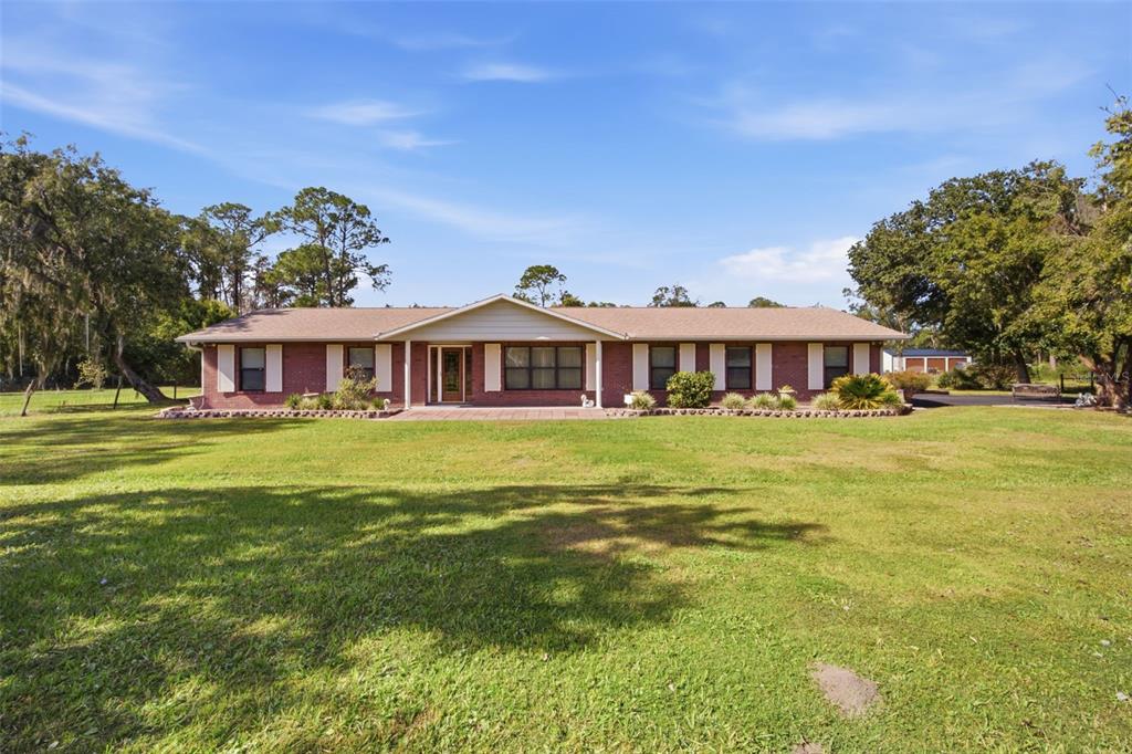 9240 Moore Road Lakeland, FL 33809 - Photo 6 of 61 a front view of a house with a yard table and chairs