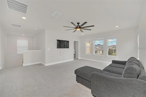 a living room with furniture and windows