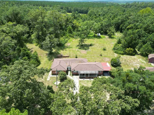 an aerial view of a house with a yard