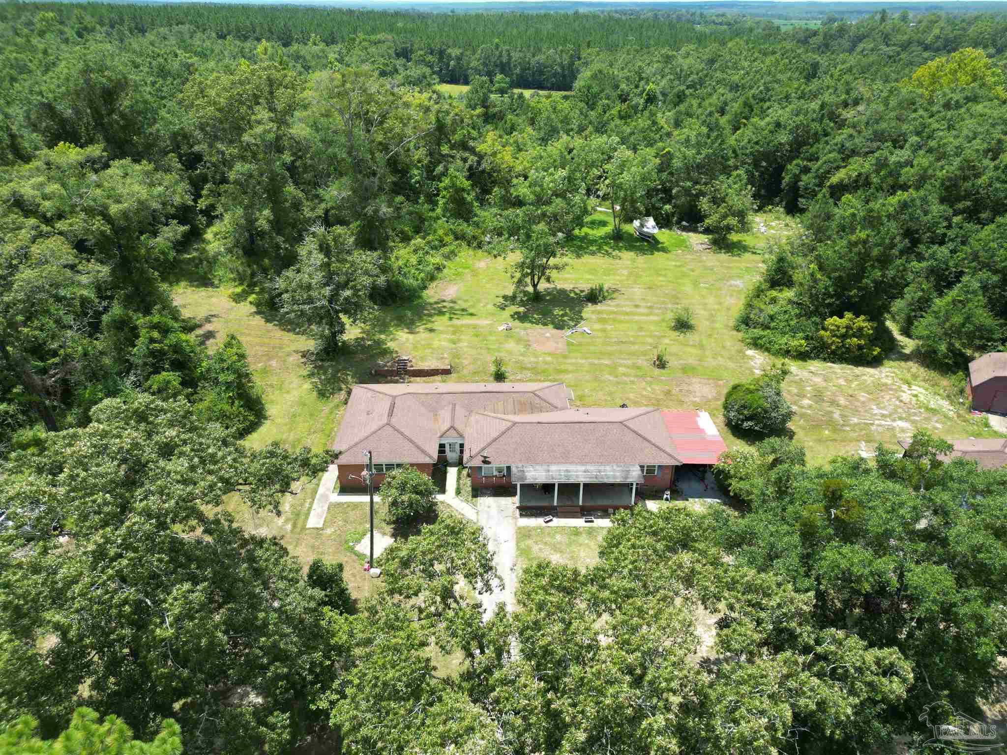 an aerial view of a house with a yard