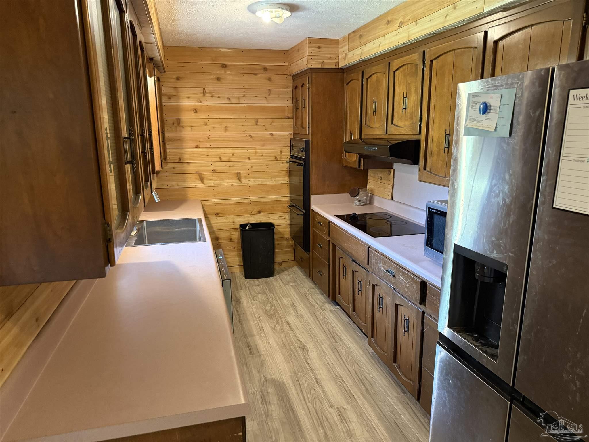 5031 Molino Road Molino, FL 32577 - Photo 12 of 37 a kitchen with stainless steel appliances a refrigerator and a stove