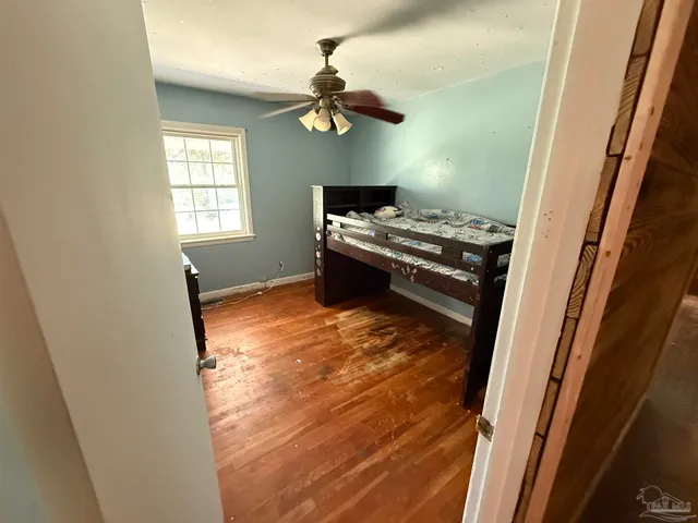 a view of a room with wooden floor and window