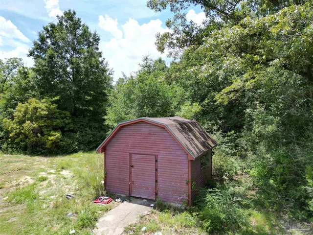 a view of a backyard with swimming pool