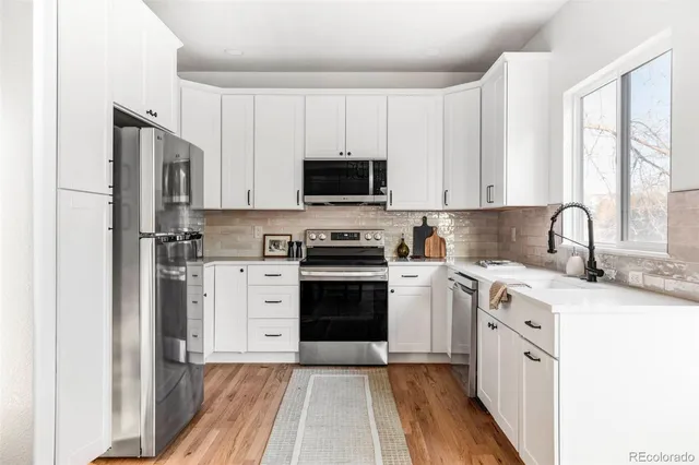 a kitchen with a stove a sink and a microwave