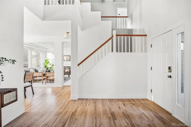 a view of entryway and hall with wooden floor