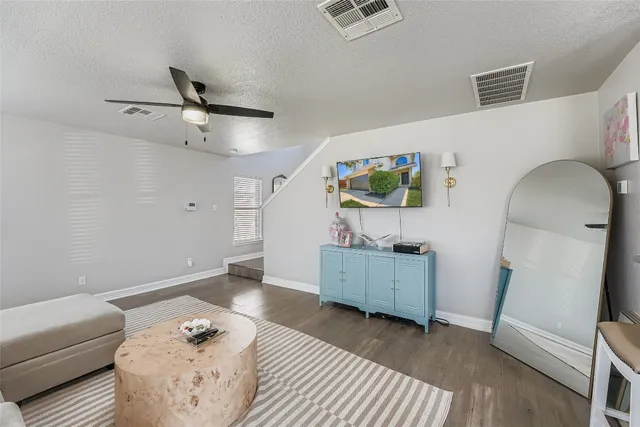 a living room with furniture and wooden floor
