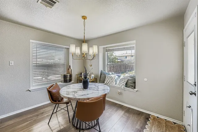 a view of a dining room with furniture window and wooden floor