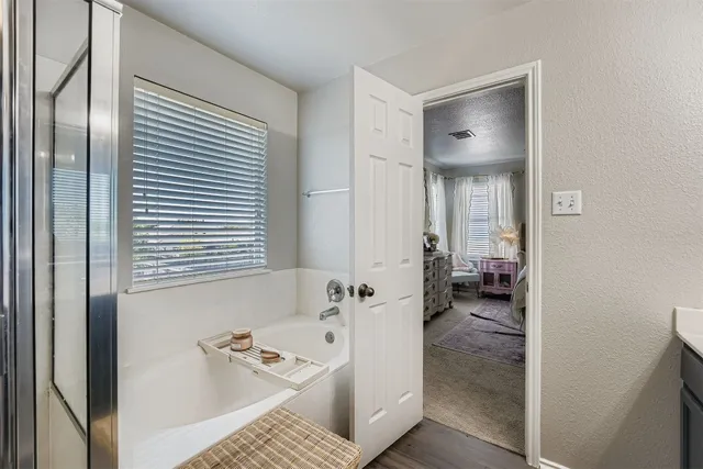 a bathroom with a tub sink and a mirror