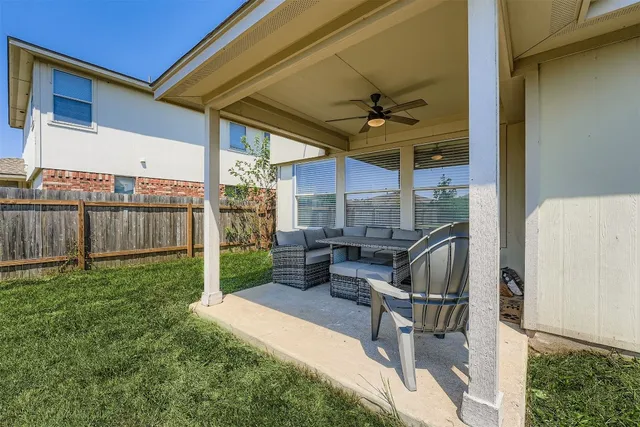 a view of a patio with table and chairs potted plants with wooden fence