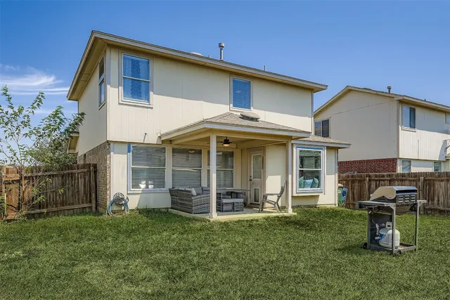 a view of a house with backyard and porch