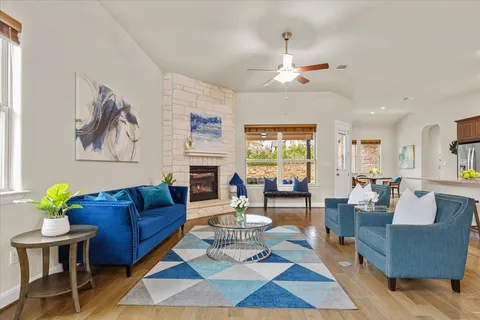 a living room with fireplace furniture and a rug