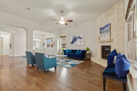 a living room with furniture fireplace and wooden floor