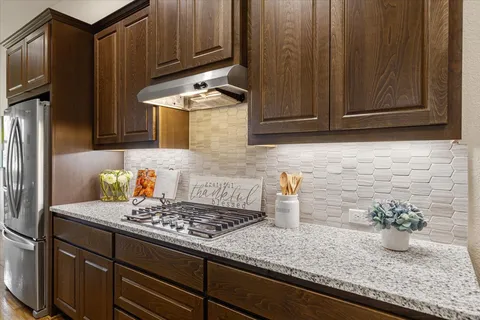 a kitchen with granite countertop cabinets and steel stainless steel appliances