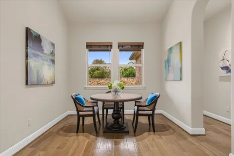 a view of a dining room with furniture and wooden floor