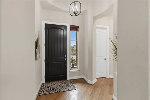 a view of an entryway with wooden floor