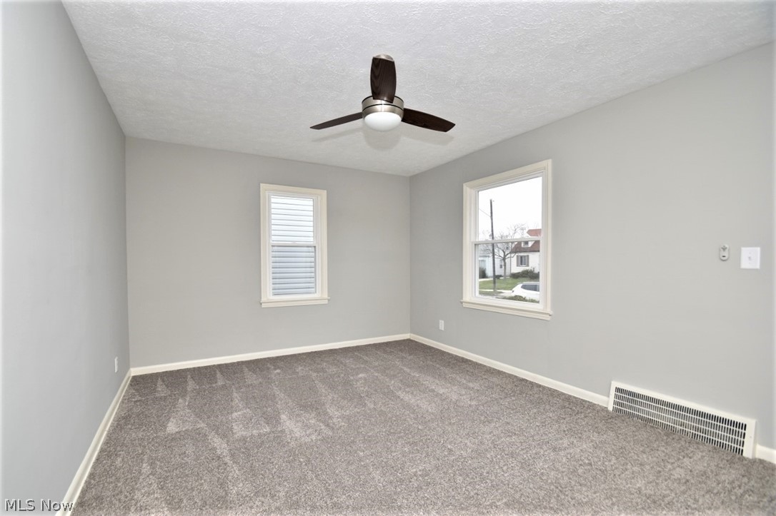 21012 Hansen Road Maple Heights, OH 44137 - Photo 3 of 28 The living room in the front of the house is freshly painted and carpeted.