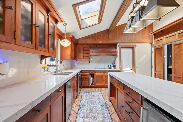 a kitchen with stainless steel appliances a sink and cabinets