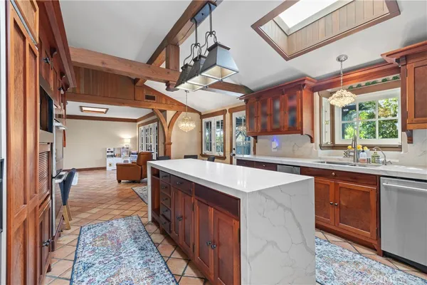 a kitchen with stainless steel appliances granite countertop a sink and cabinets