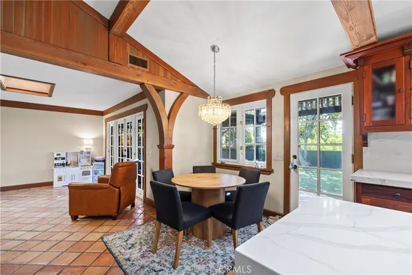 a living room with furniture a table and a large window
