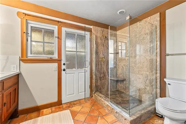 a bathroom with a glass shower door