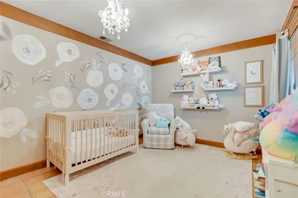 a bedroom with furniture and a large window