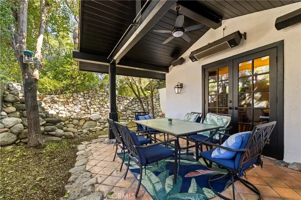 a view of a patio with table and chairs and potted plants