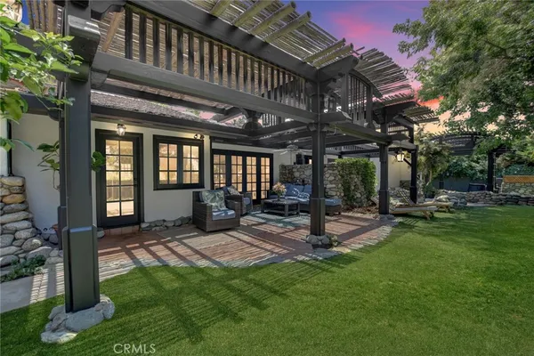 a view of a backyard with sitting area furniture and garden