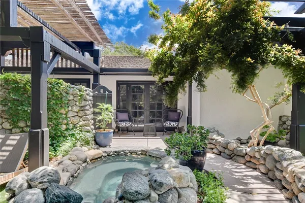 a view of a house with a chairs in patio