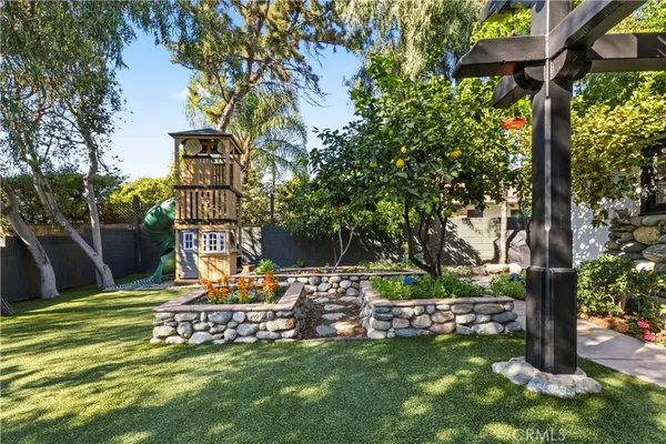 a view of a backyard with table and chairs and a large tree