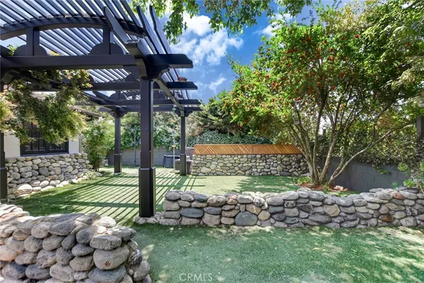 a view of a house with backyard porch and sitting area
