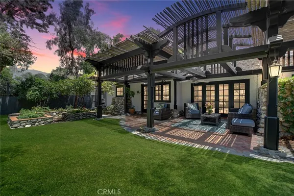 a view of a chairs and tables in the back yard of the house