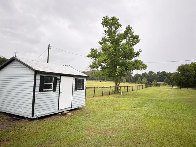 a view of a house with a backyard