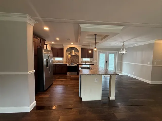 a large kitchen with a table and chairs