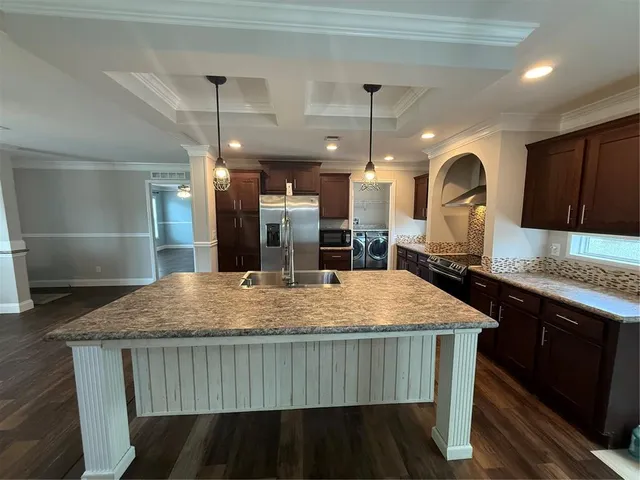 a large kitchen with a table and chairs