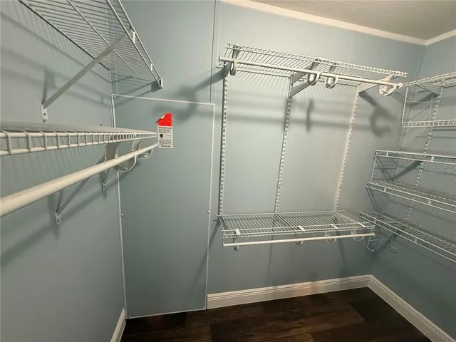 a kitchen with granite countertop a sink cabinets and wooden floor