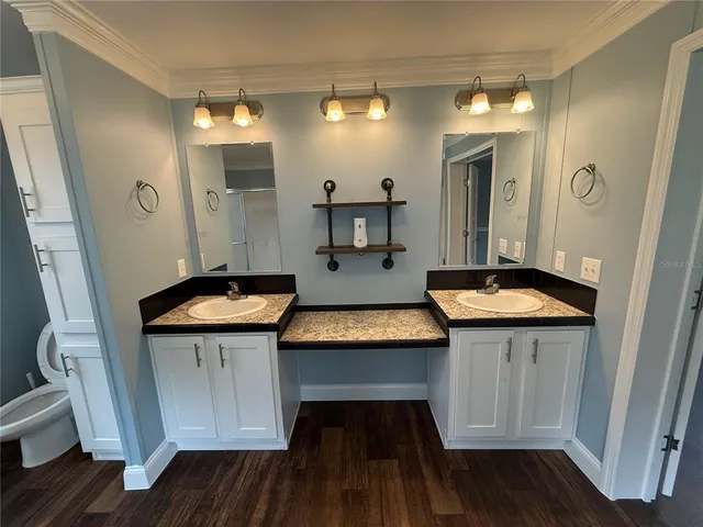 a room with wooden floor and windows