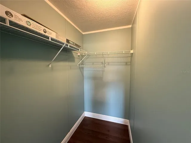 a large white room with a large mirror and a sink