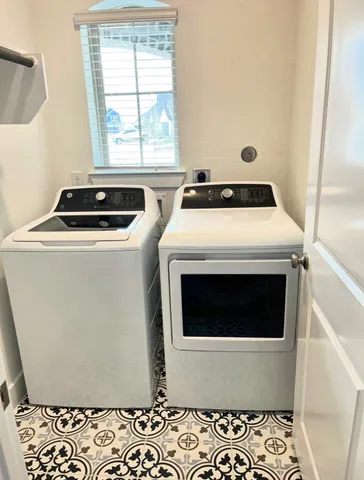 a bedroom with a bed and a potted plant