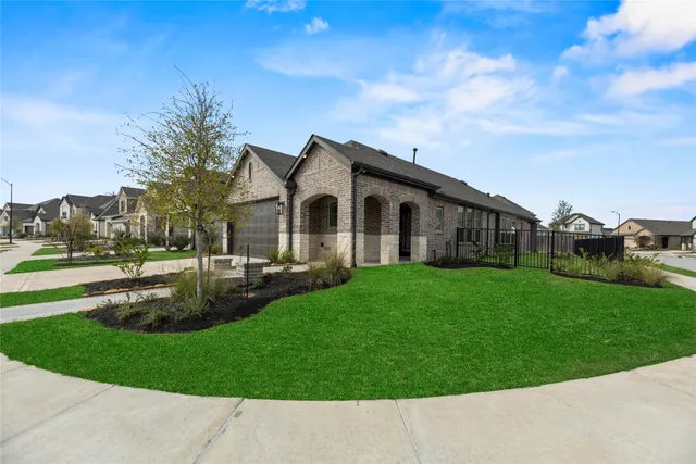 an aerial view of residential houses with outdoor space and river