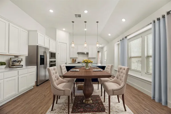 a living room with furniture kitchen view and a large window