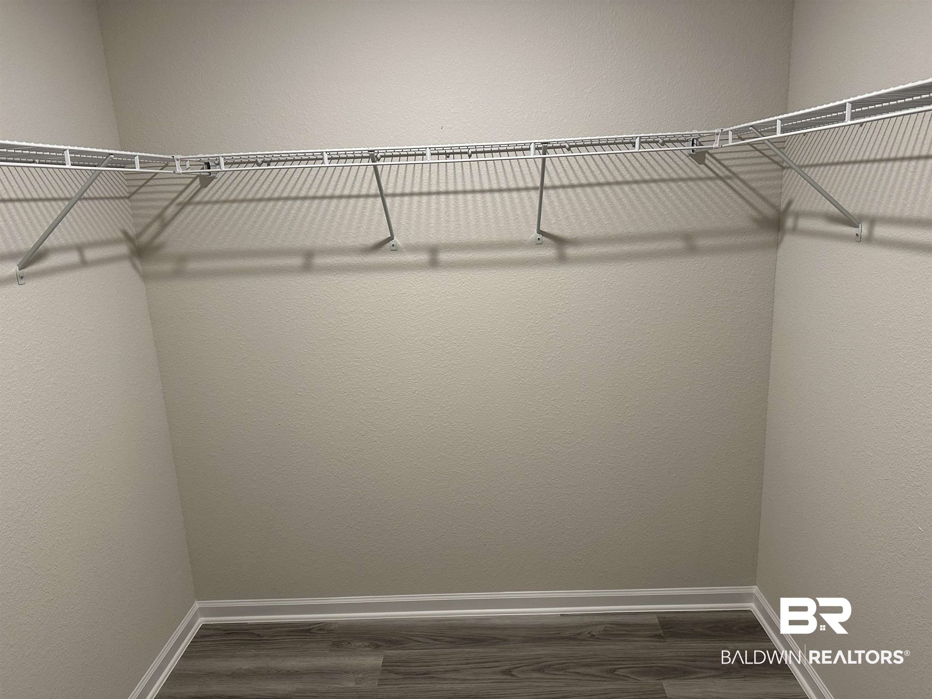 1238 Hayward Loop Foley, AL 36535 - Photo 36 of 46 Walk in closet featuring dark wood-type flooring