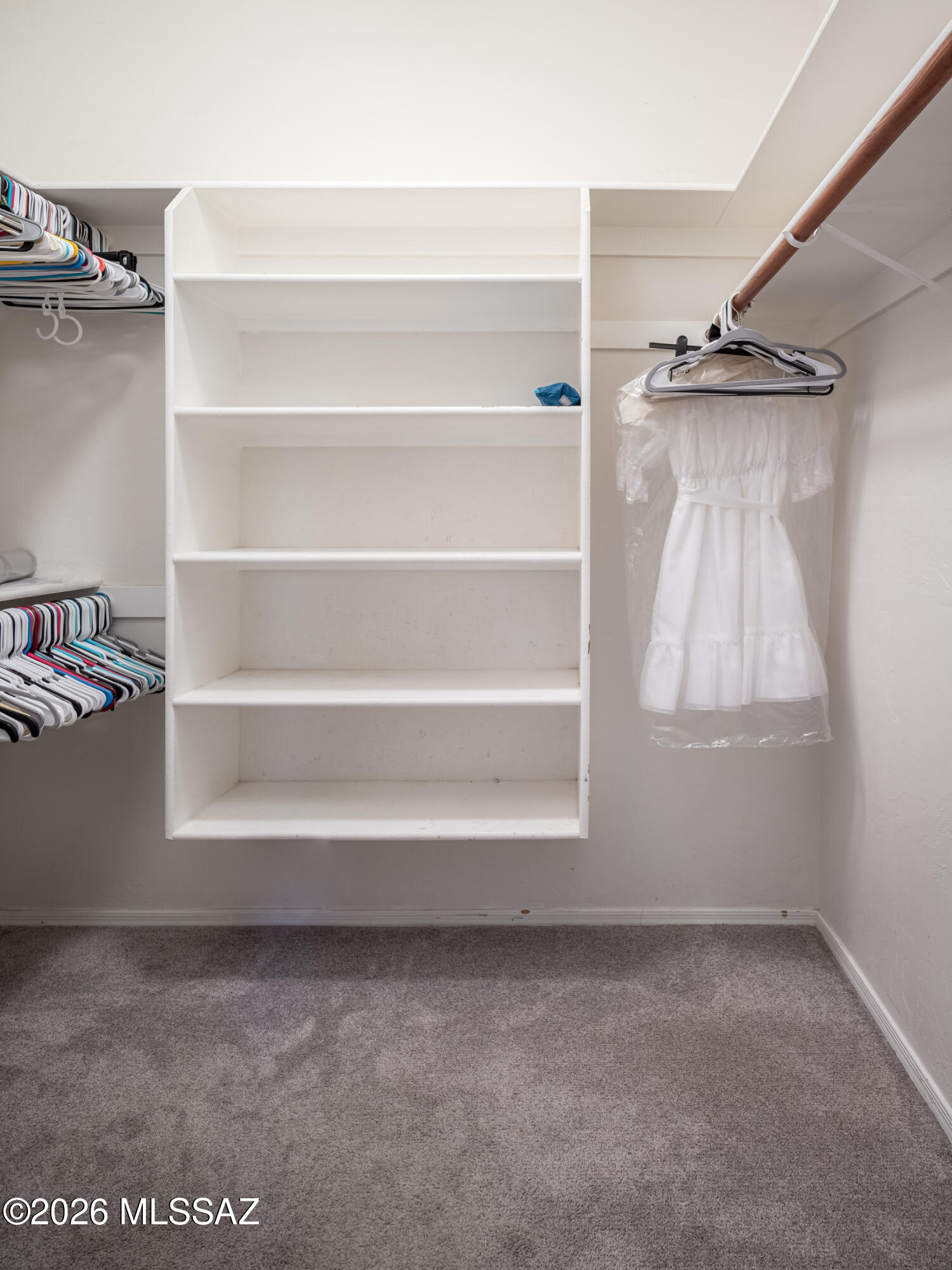 7140 West Maple Ridge Drive Tucson, AZ 85743 - Photo 13 of 33 Large walk-in closet with built in shelving.