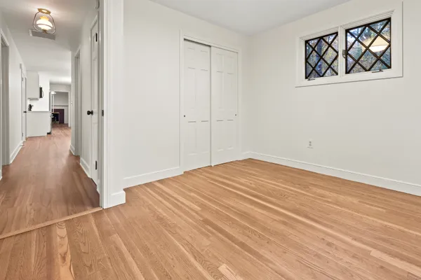 a view of an empty room with wooden floor