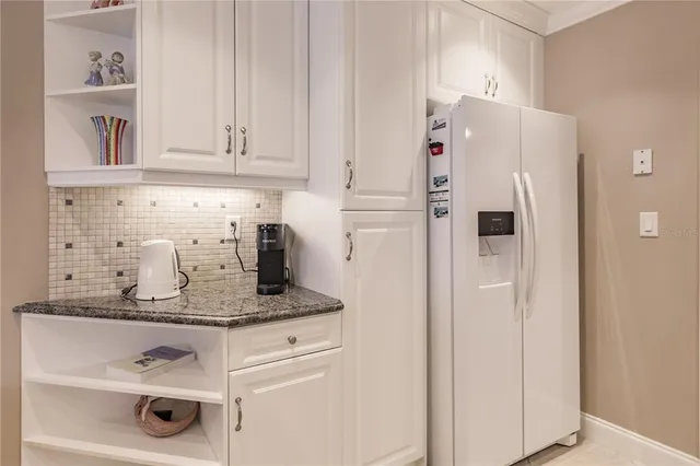 a white refrigerator freezer sitting inside of a kitchen