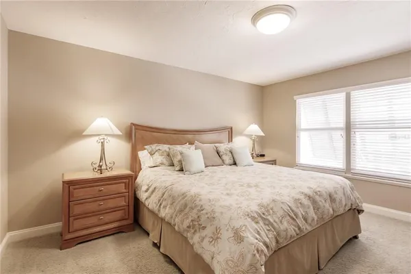 a bedroom with a bed and a night stand