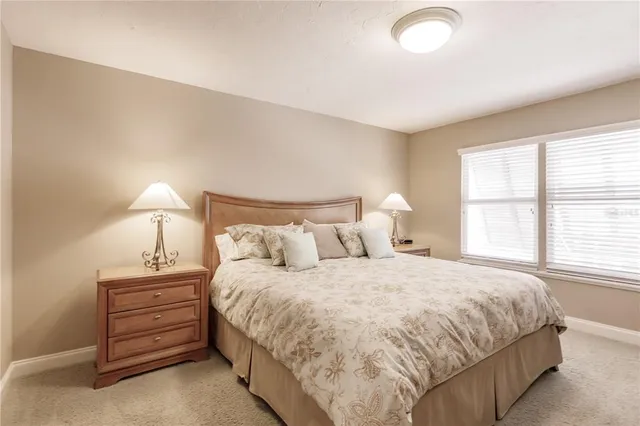 a bedroom with a bed and a night stand