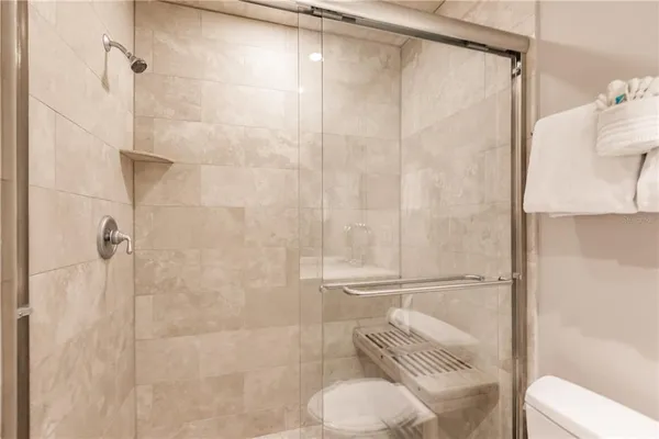 a bathroom with a shower and toilet