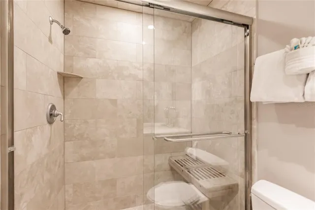 a bathroom with a shower and toilet